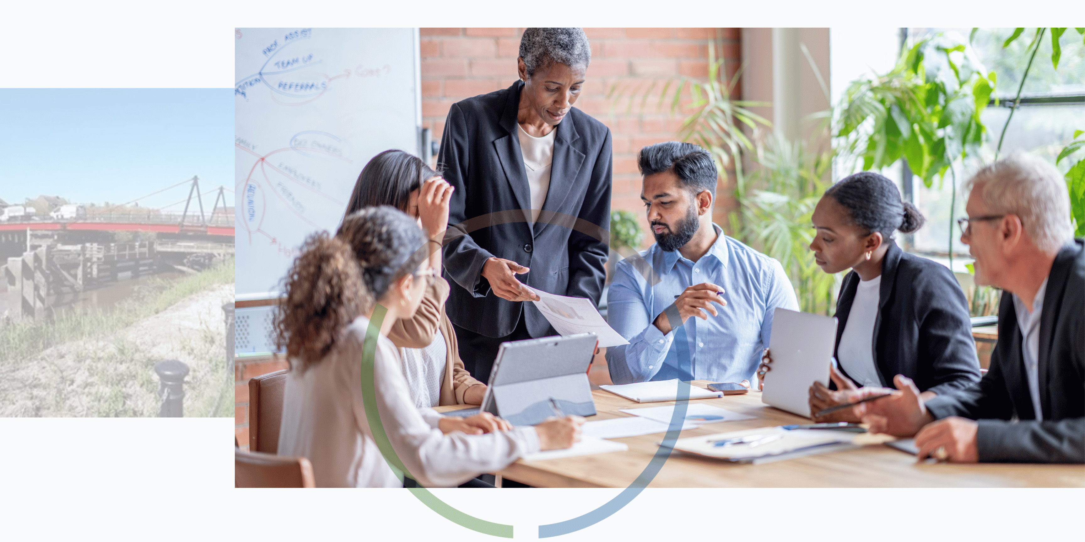 Group of people sitting around desk in office