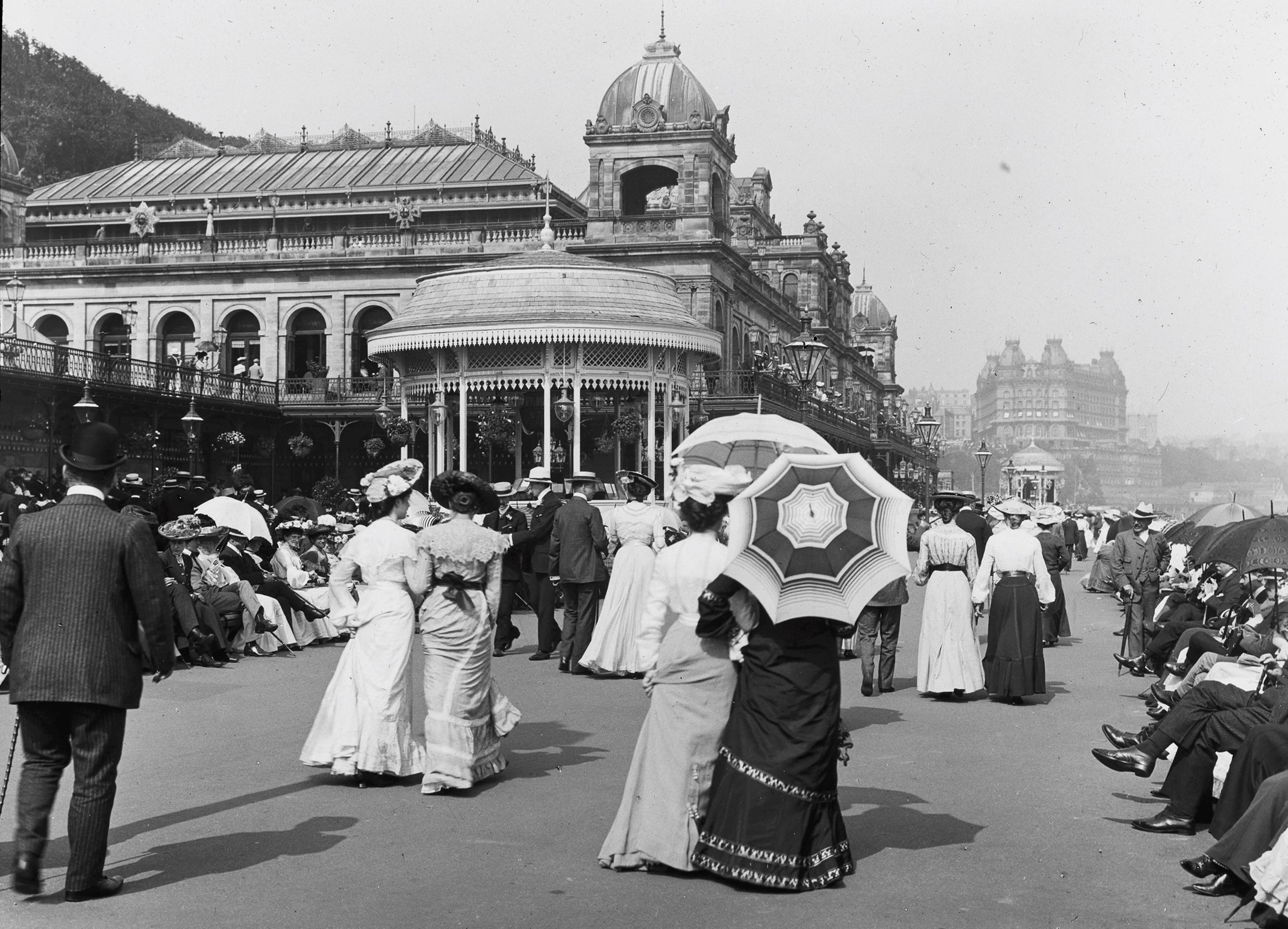 Black and white photo of groups of people walking along the Scarborough South Bay promenade
