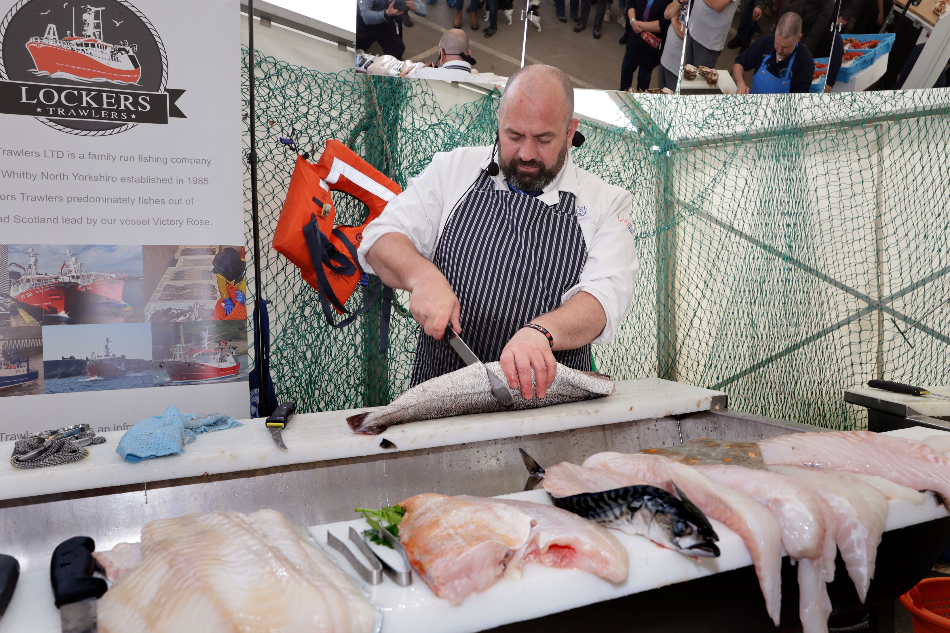 A chef cutting fish at Whitby Fish and Ships Festival