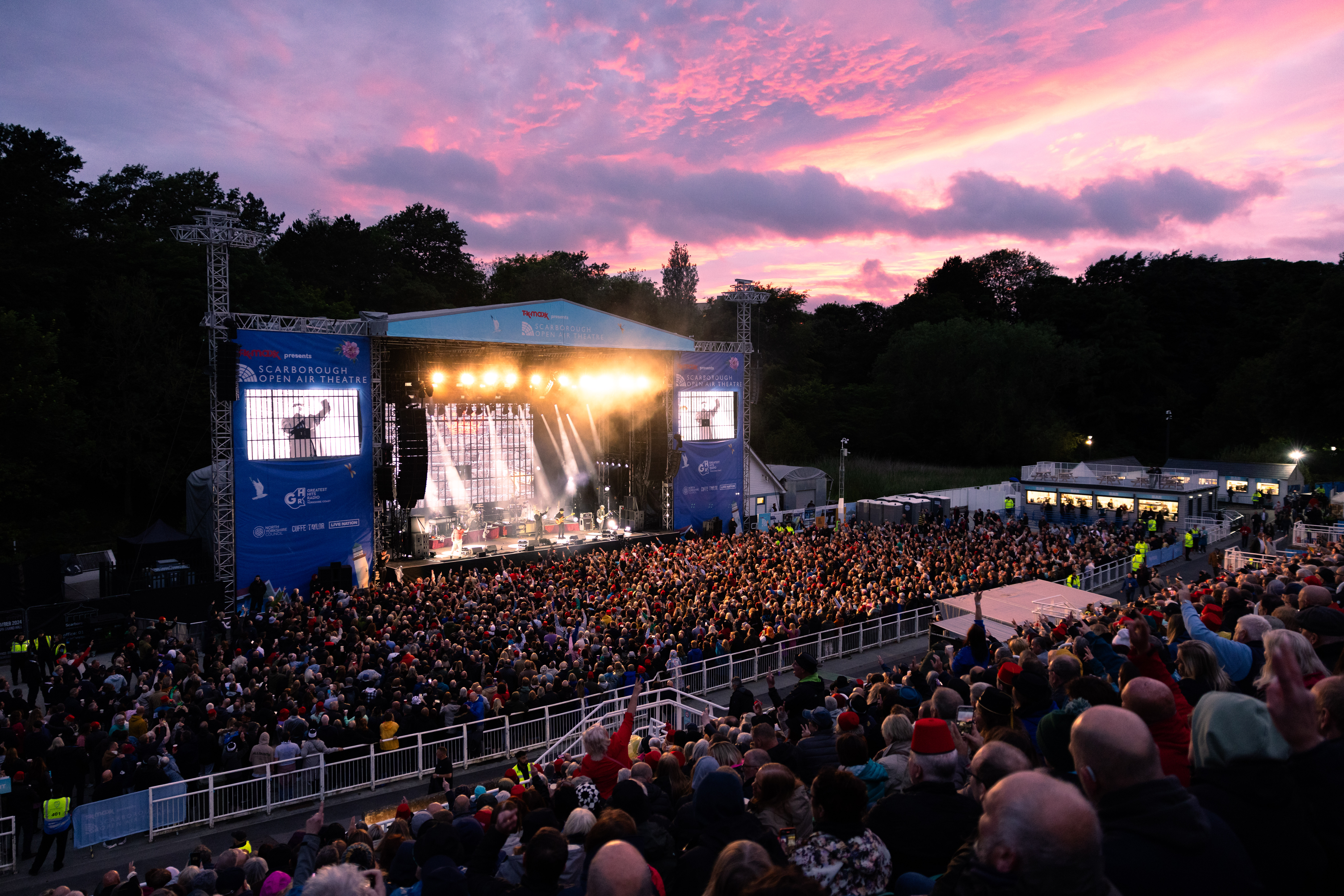 Crowds watching a show at the Scarborough Open Air Theatre in the evening