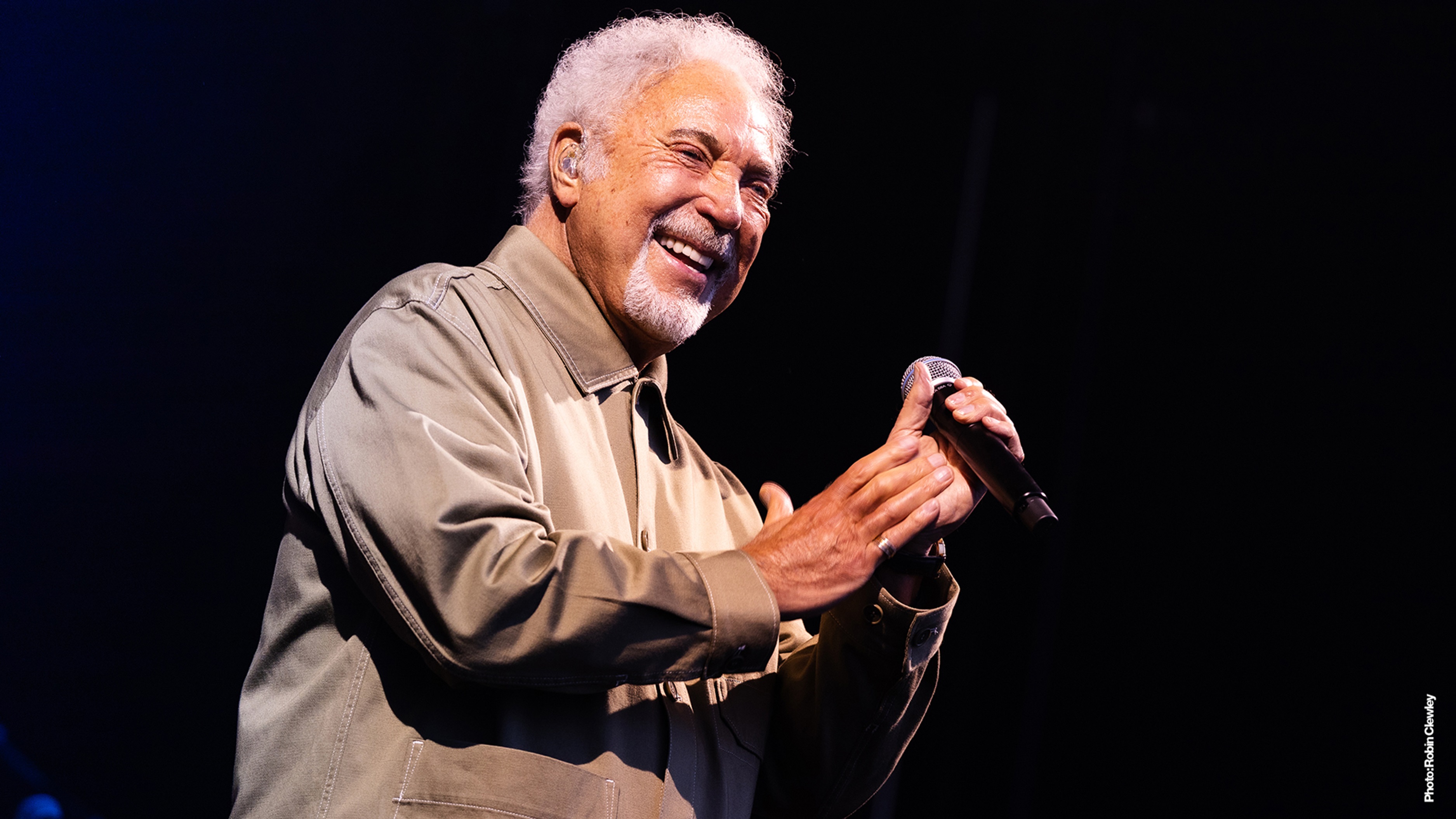Sir Tom Jones standing with a microphone