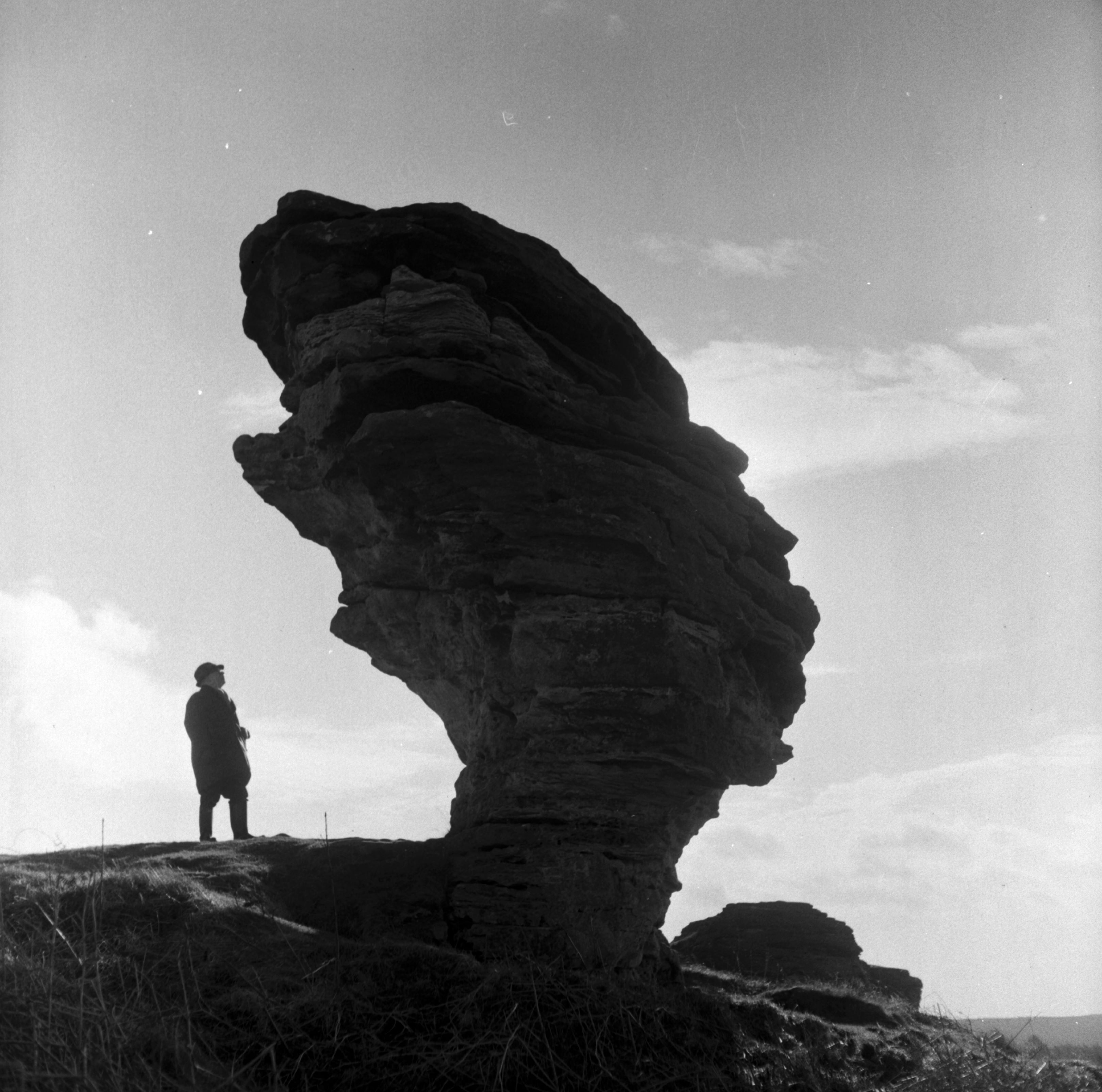 Standing below The Bridestones, weathered sandstone outcrops on Allerston High Moor, North York Moors. Taken by local photographer Bertram Unné, active between 1940 and 1979.