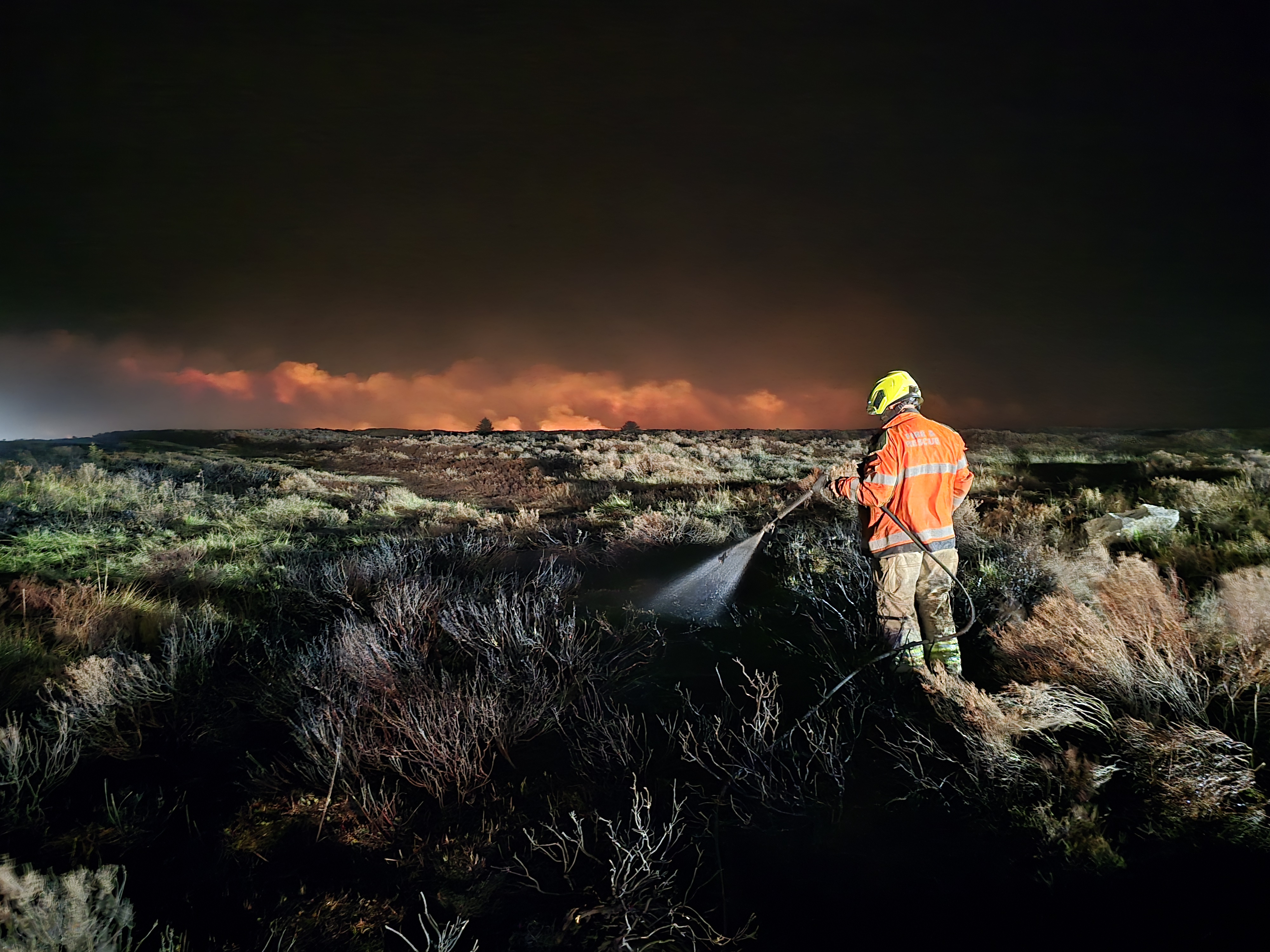 A firefighter with the moors fire - Credit Paul Edwards