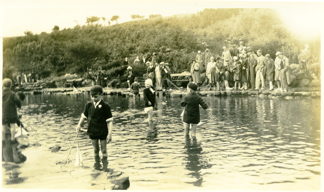 Children are pictured paddling in the shallow model yacht ponds at Peasholm Lake in Scarborough. From a collection of Scarborough and Whitby photographs dating from 1929.