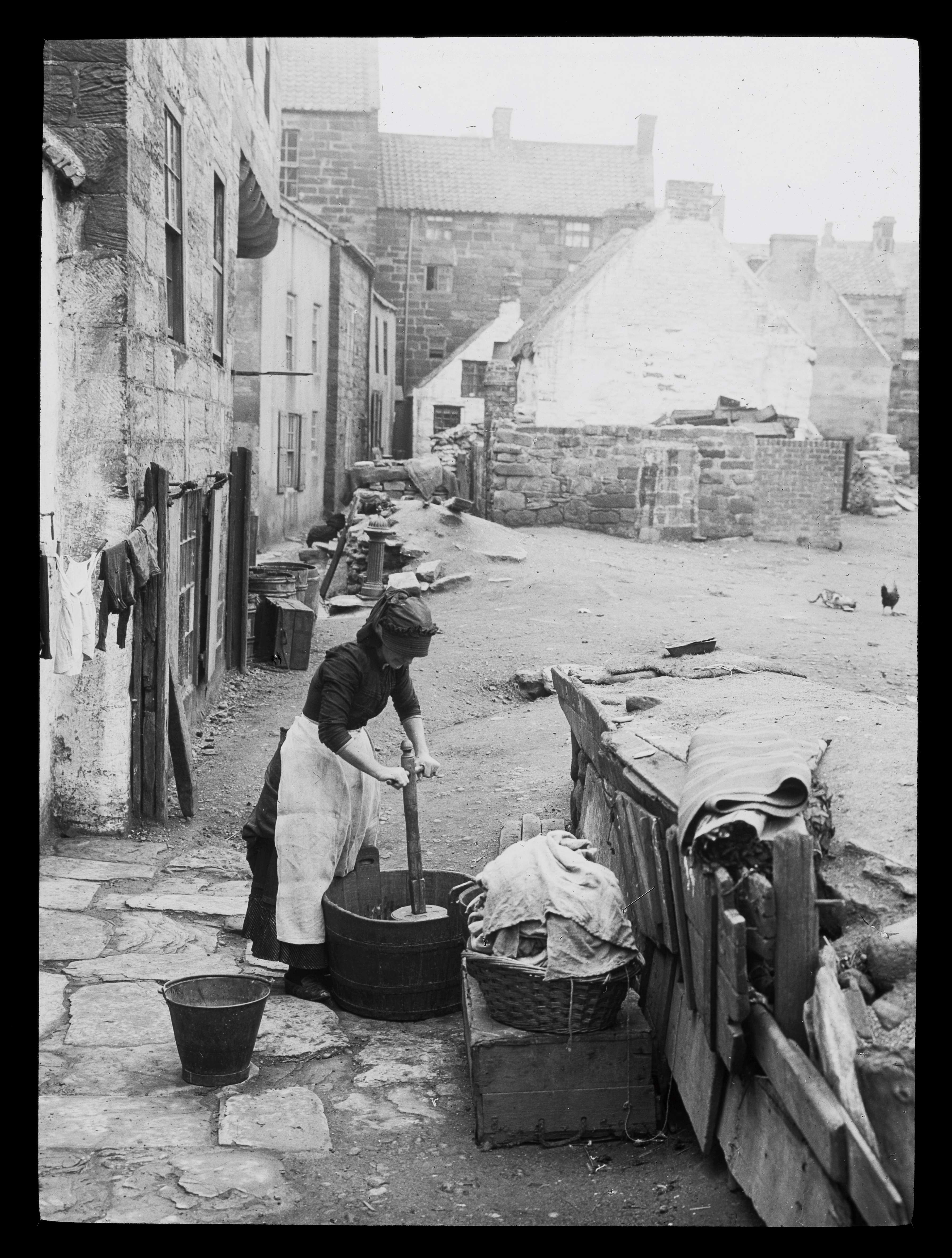A woman is pictured doing her laundry during a washing day in Staithes. The photo is undated and was taken by Graystone Bird (1862-1943). It is taken from the ‘Tour of Yorkshire’ photographic collection