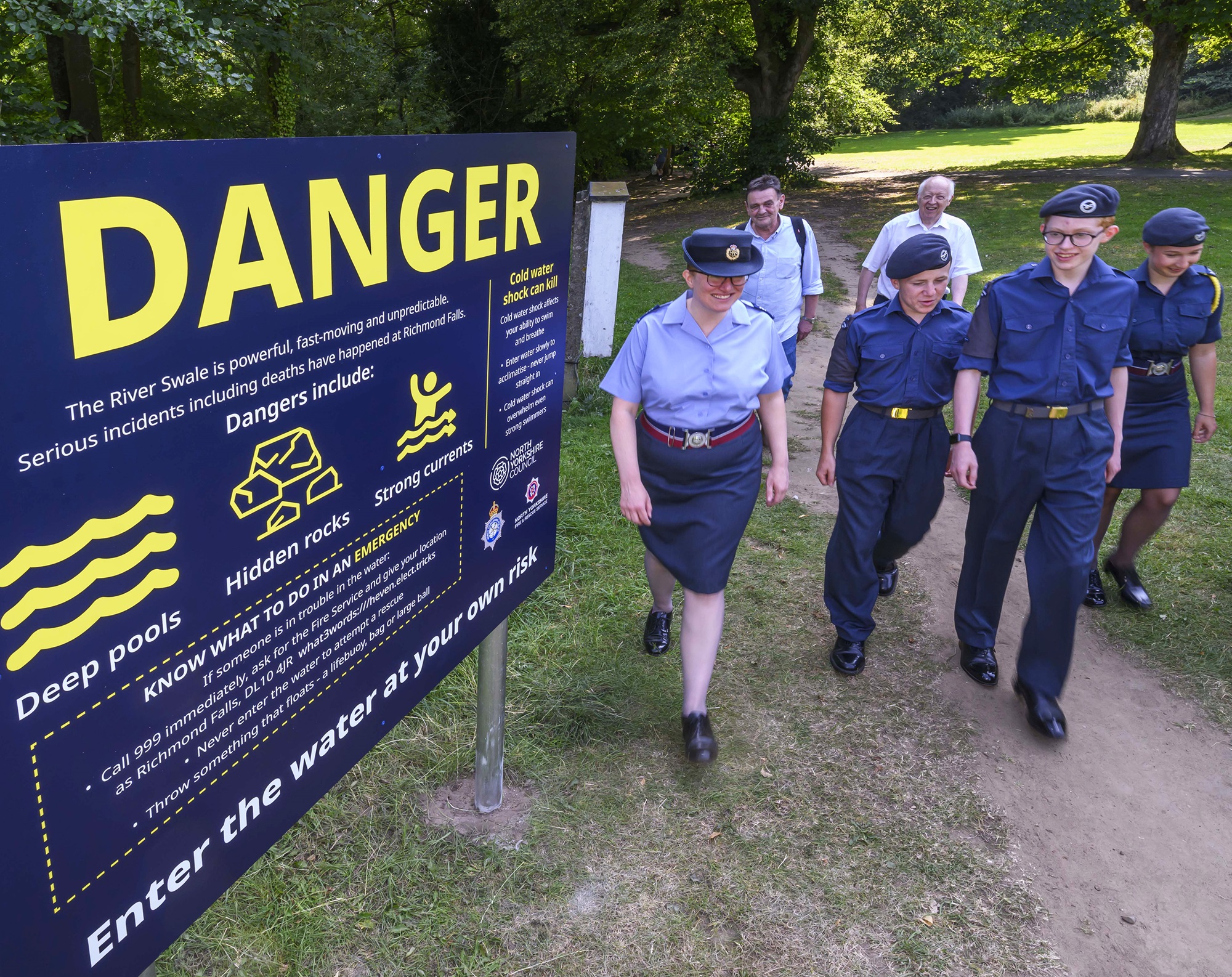 People walking next to the Richmond falls sign