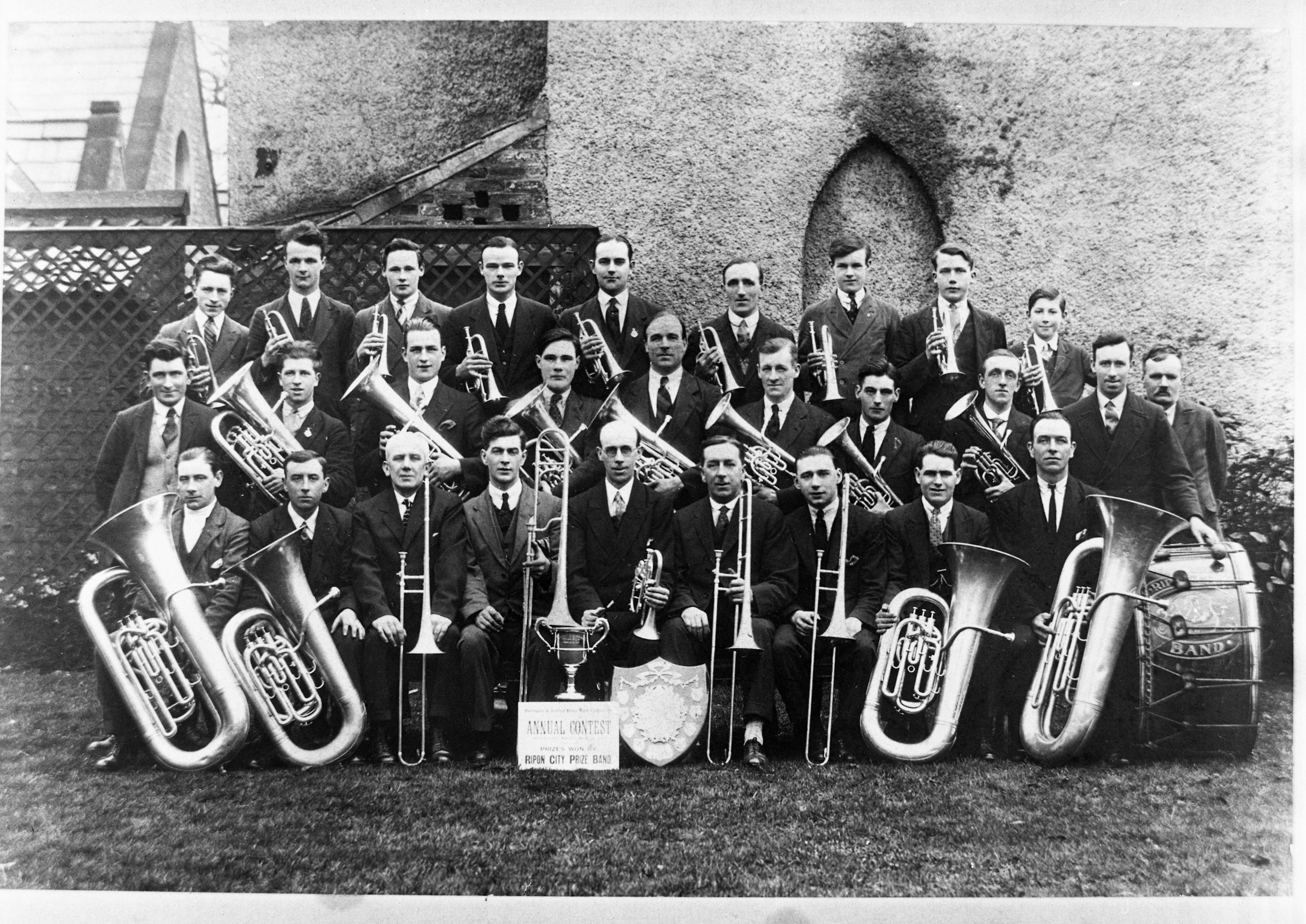 Ripon City Band, which formed in 1860, are pictured after winning the first prize in an annual brass band competition in 1928. This image is part of the Ripon Re-Viewed collection created by Ripon Civic Society and supported by the National Lottery Heritage Fund (NLHF).