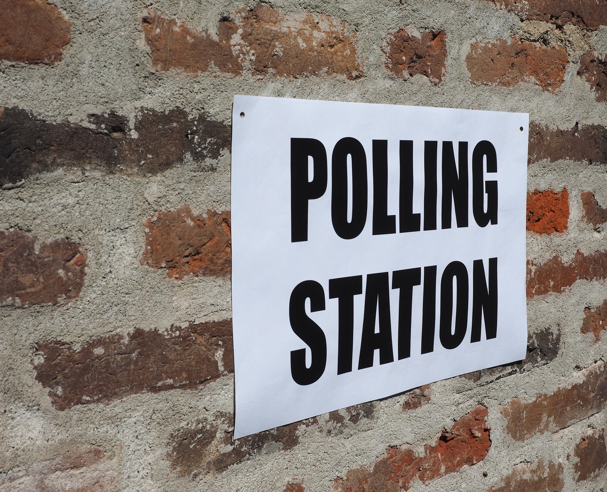 Polling Station sign on a brick wall