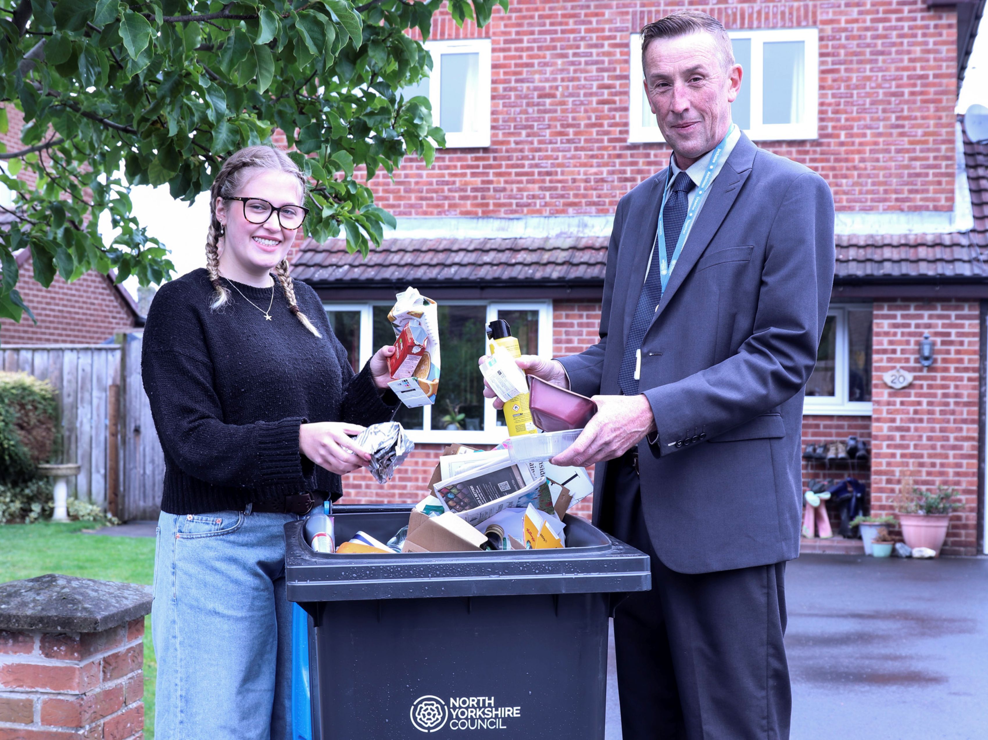  resident Alexis Flint shows how to recycle waste correctly with North Yorkshire Council’s executive member for managing our environment, Cllr Richard Foster.