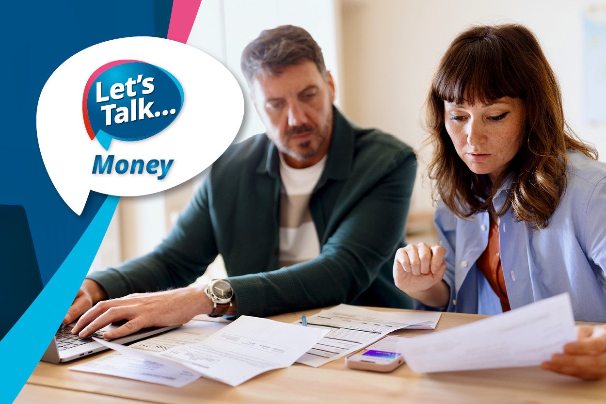 A man and a woman are looking at papers and using a calculator next to the Let's Talk Money logo
