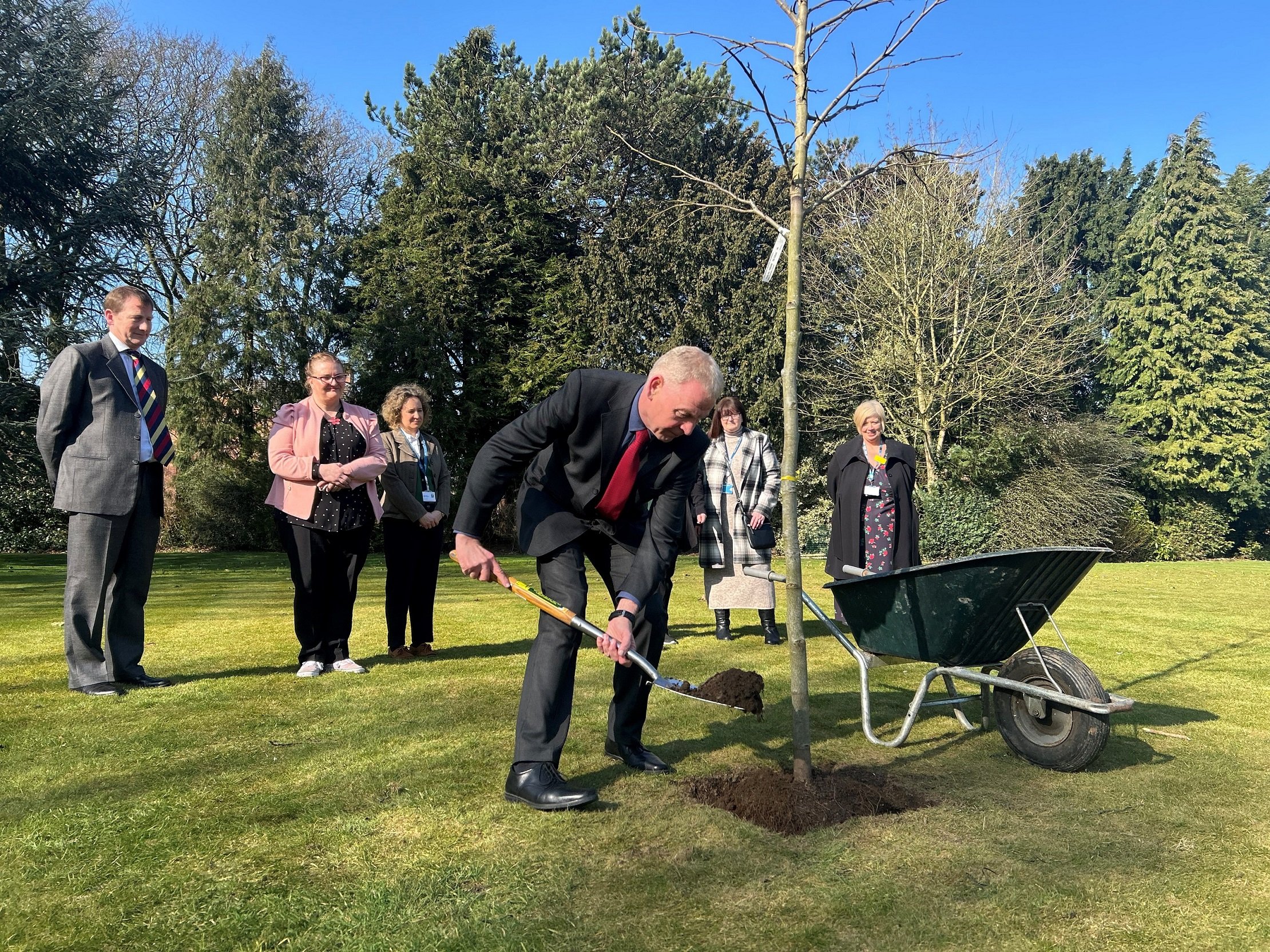 North Yorkshire Council’s chief executive, Richard Flinton, centre, at the tree-planting ceremony. Left to right in the background are Dr James Dunbar, a consultant in infection and general medicine at the Friarage Hospital in Northallerton, staff nurse Helen Sharpe, the council’s public health manager, Emma Davis, reablement care and support worker Julie Samways, and the chief executive officer for the South Tees Hospitals NHS Foundation Trust, Stacey Hunter.