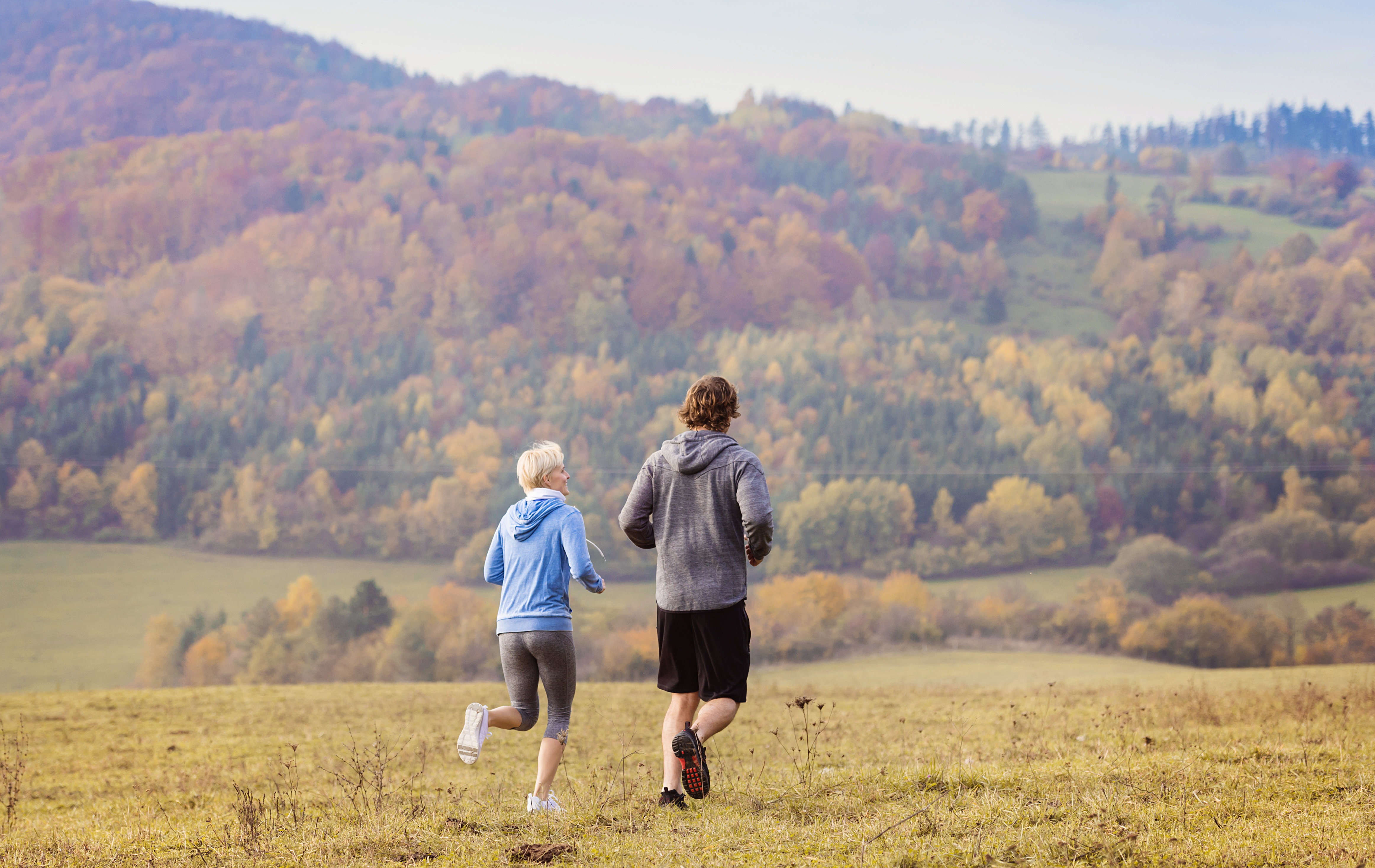 A mum running in the hills with her son.