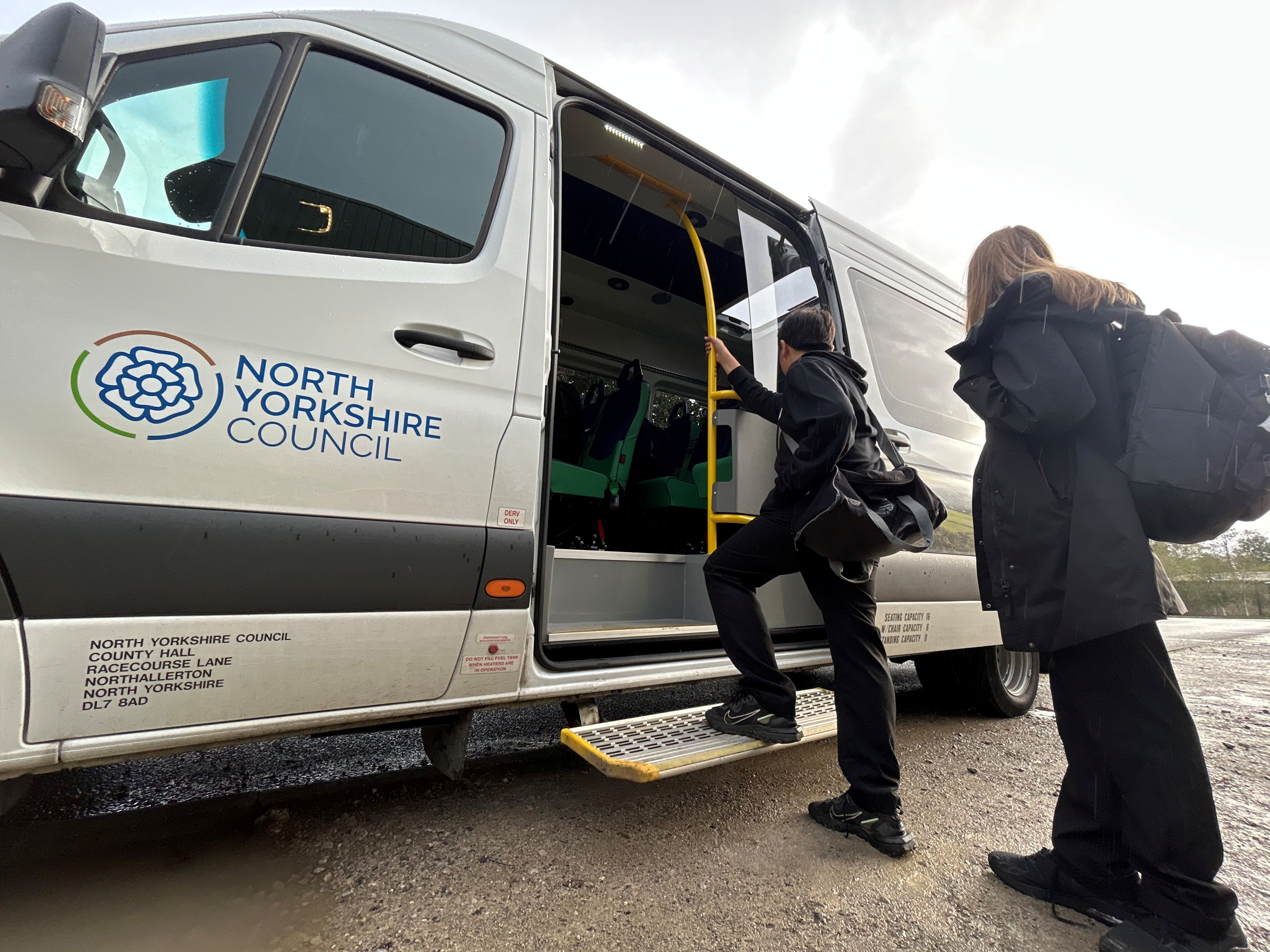 Children climbing onboard a school minibus