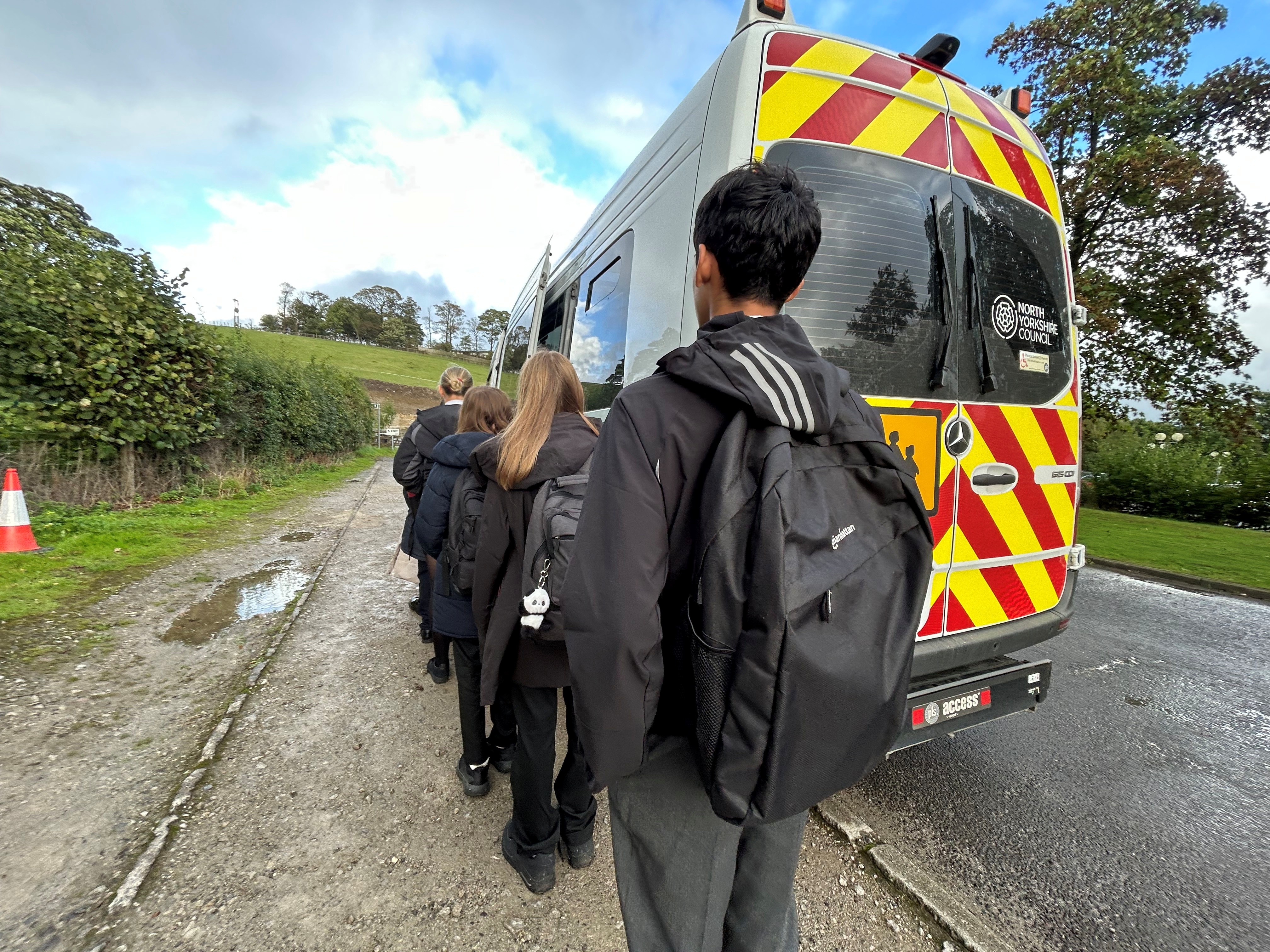 Children waiting to get on the school minibus