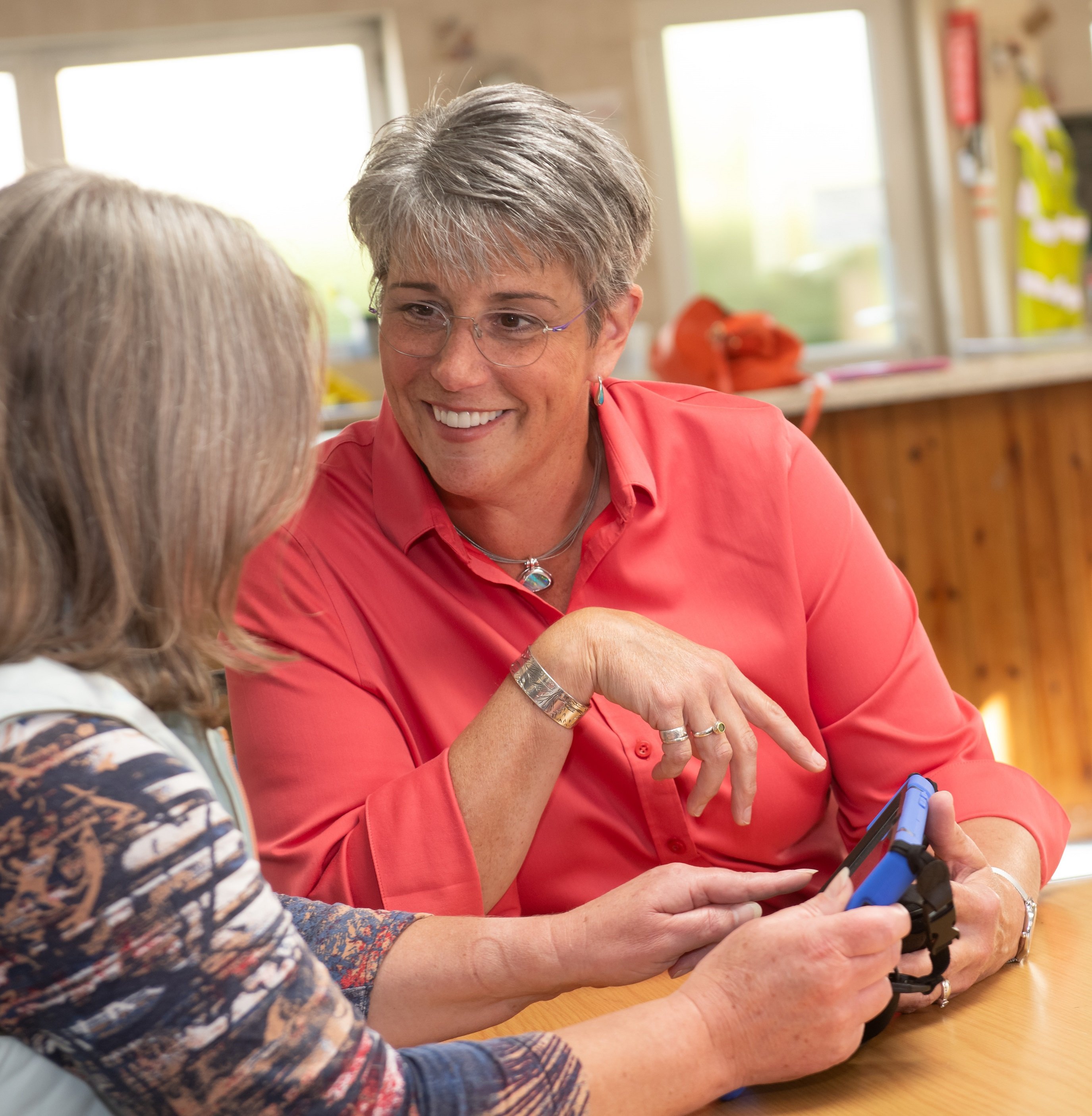 Two ladies looking at a tablet