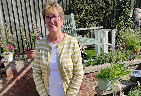 A photo of Angela English standing in her garden