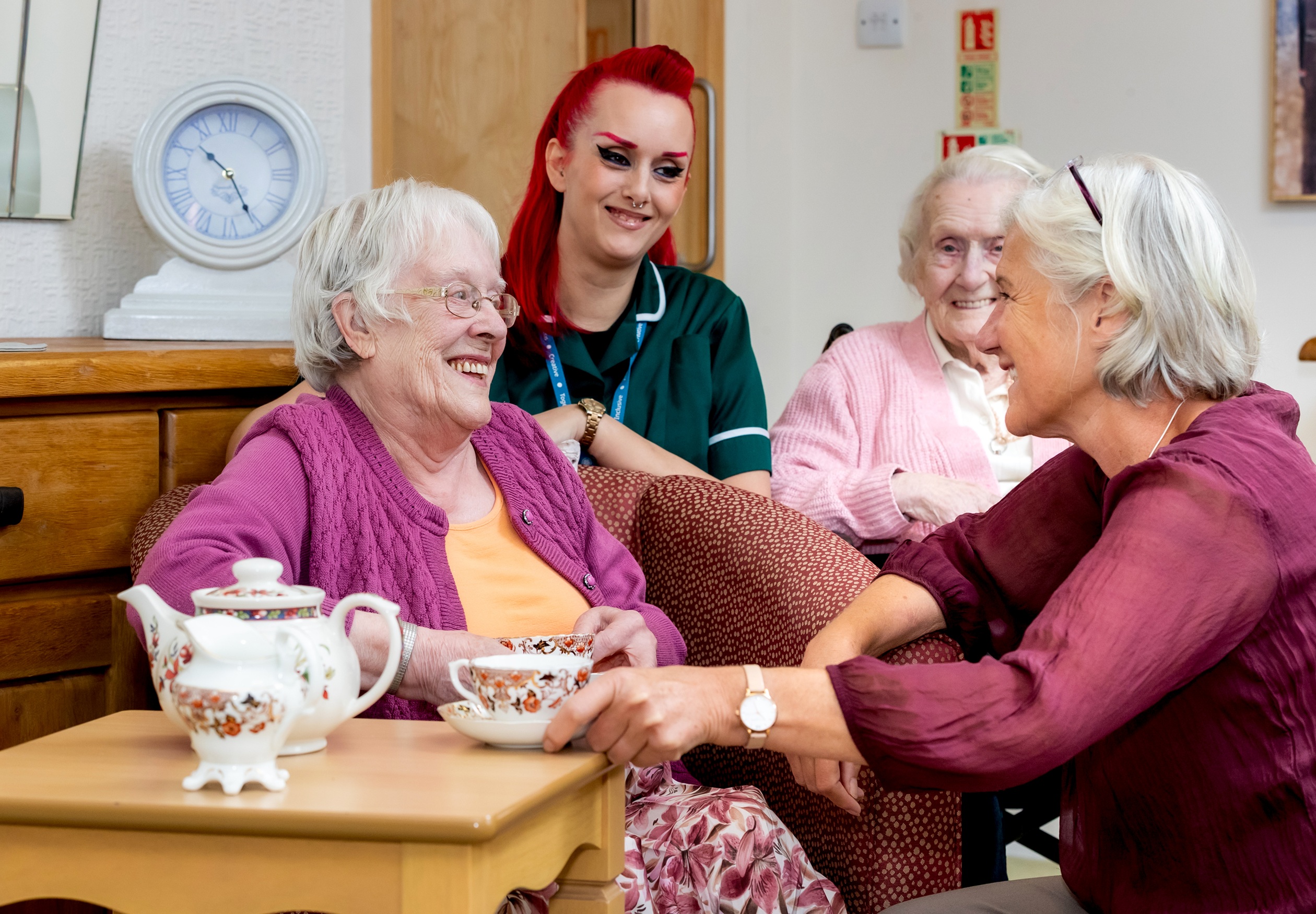 Three older ladies and a care worker