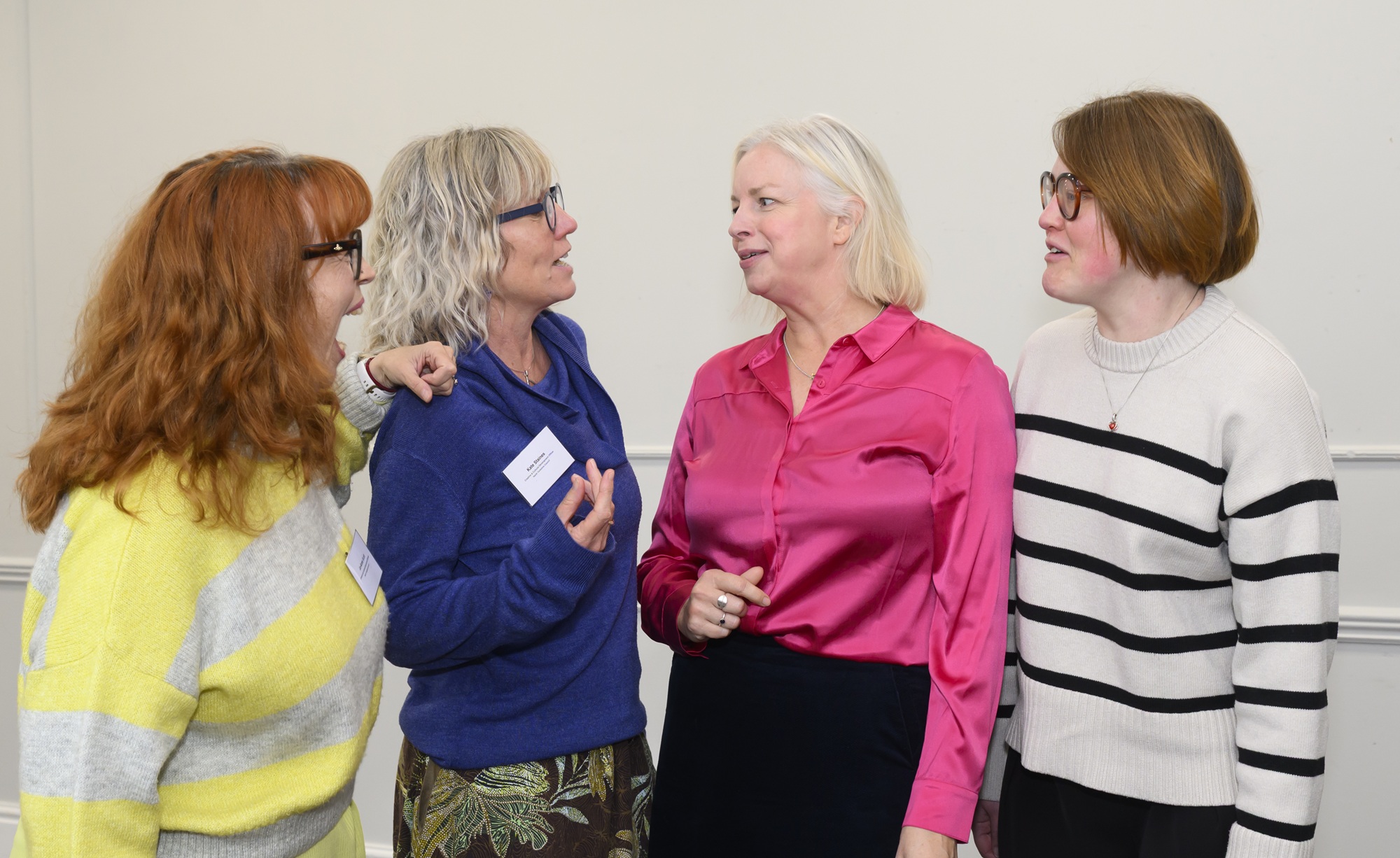Four ladies stood talking