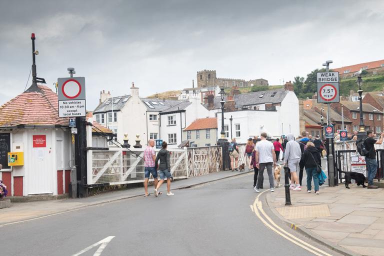 People walking over Whitby Swing Bridge