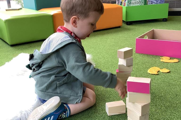 A young boy playing with blocks