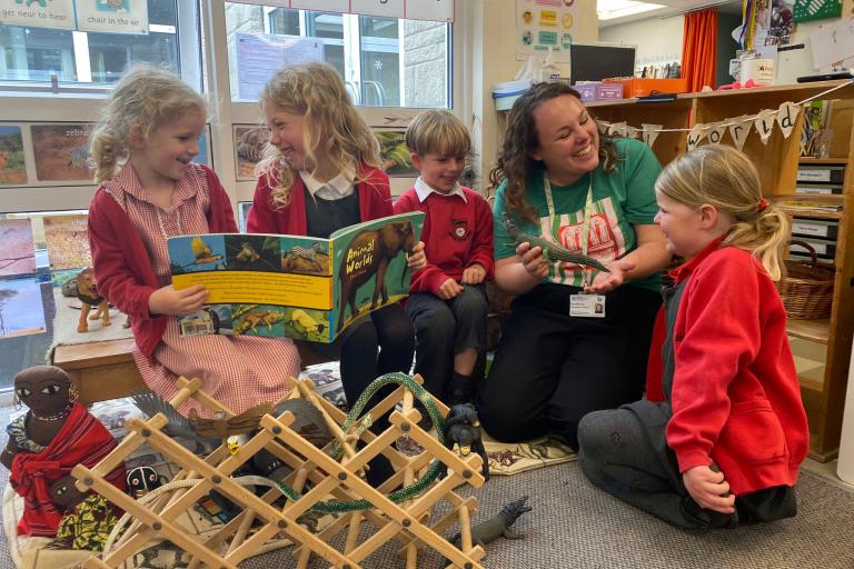 A group of children and a teacher reading