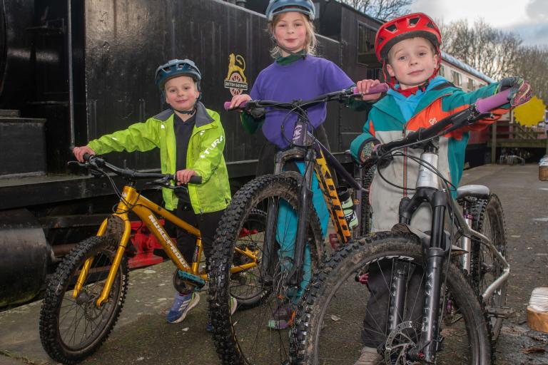 Three young children on a bike