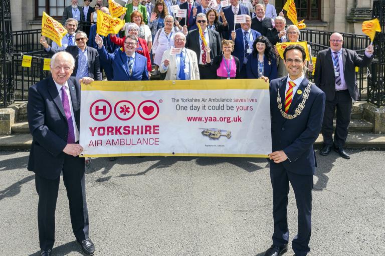 Elected members with a Great North Air Ambulance banner