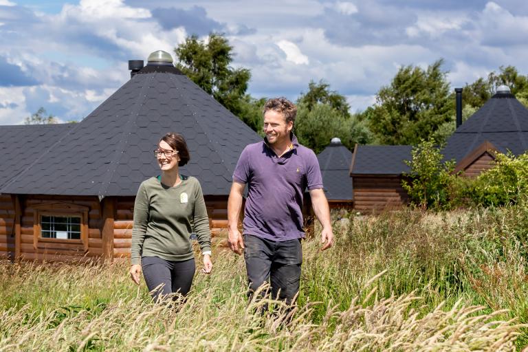 Joanne and Sean Nicholson outside glamping pods that have been introduced at her family’s farm