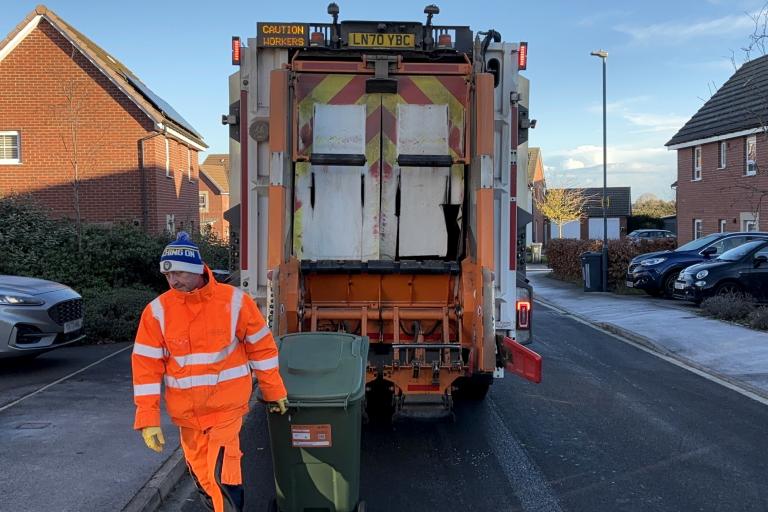 A man collecting the garden waste