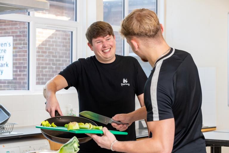 Two men cooking