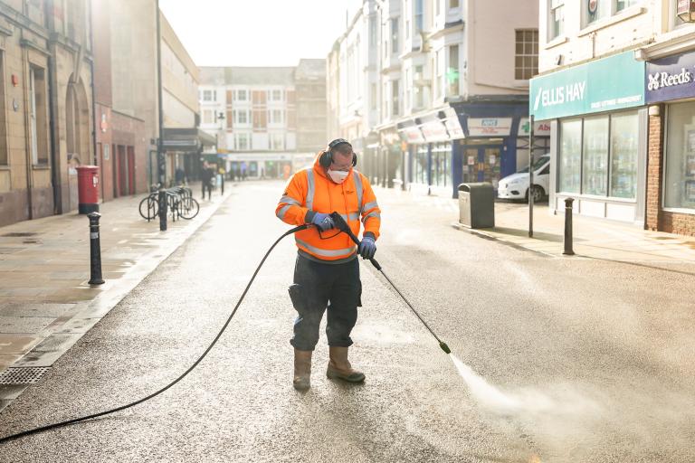 A person cleaning chewing gum