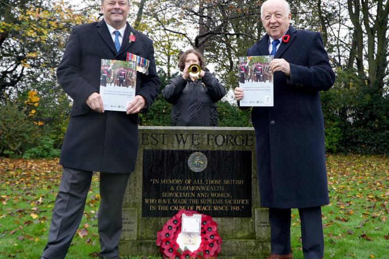 Two men holding the guide for Armed Forces personnel