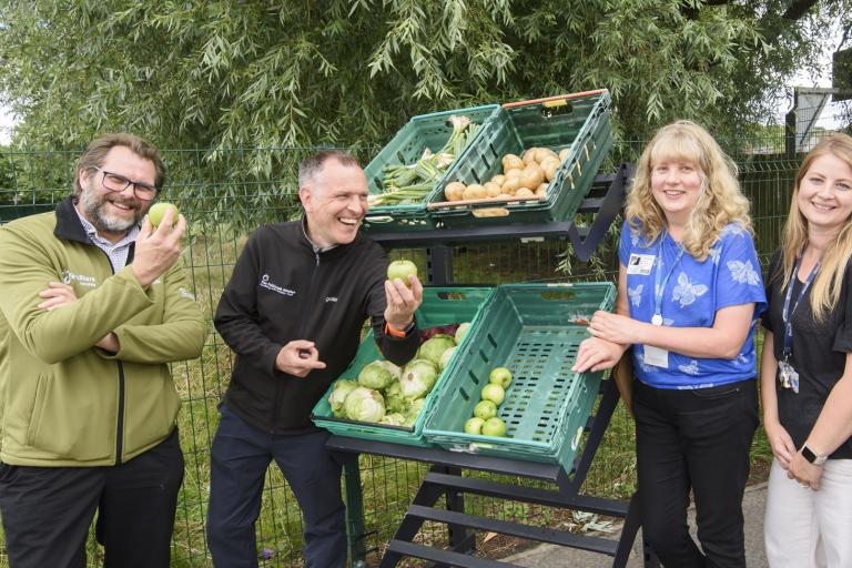 Four people with apples