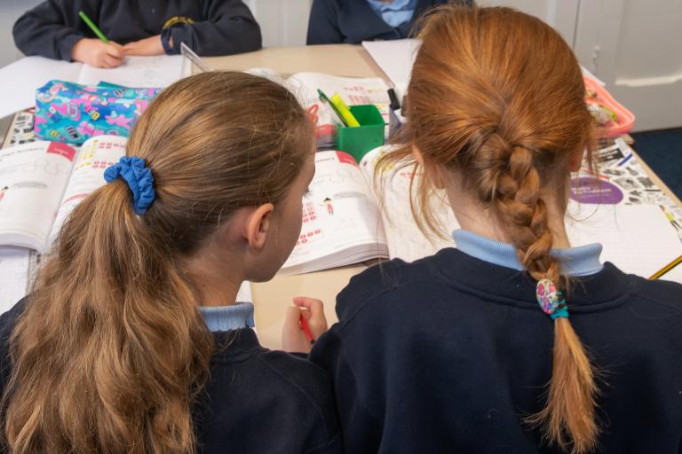 Two young girls in school