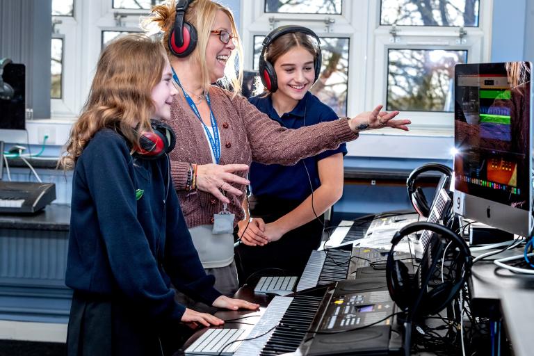 Wensleydale School’s headteacher Julia Polley is pictured with pupils Nina Wilmington, left, and Lilly Dalton using keyboards and state-of-the-art computer software to compose music.