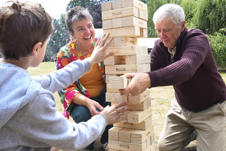 Ruth Ive with her husband Andy and a child playing Jenga