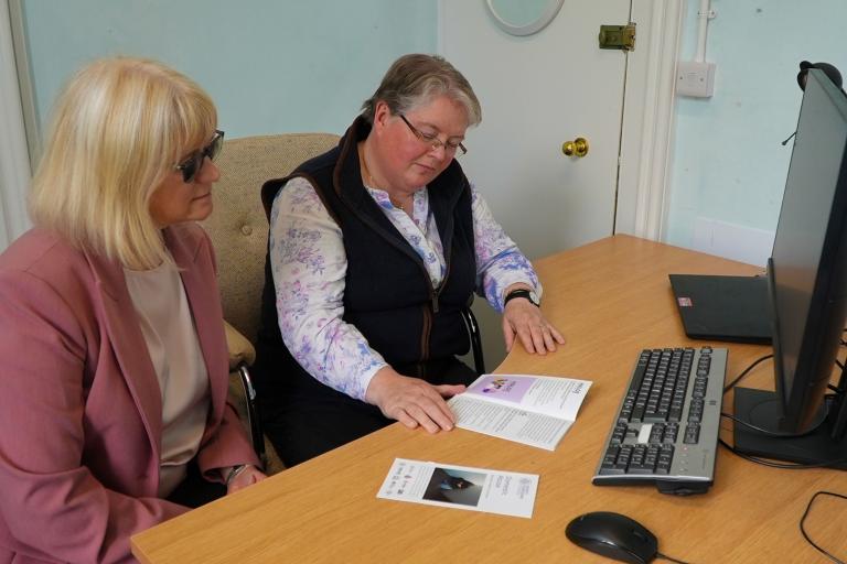 Two people sat in front of a computer