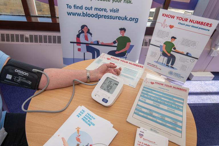 Someone taking a blood pressure reading