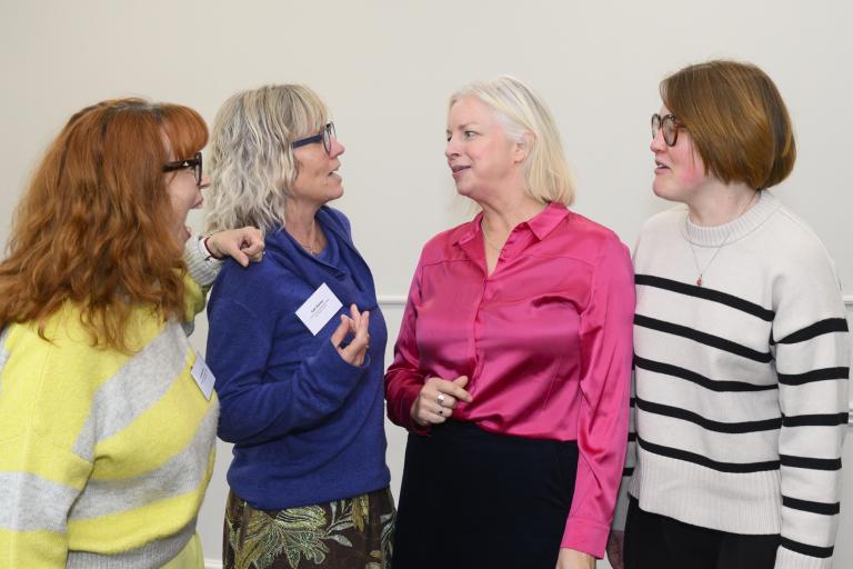 Four ladies stood talking