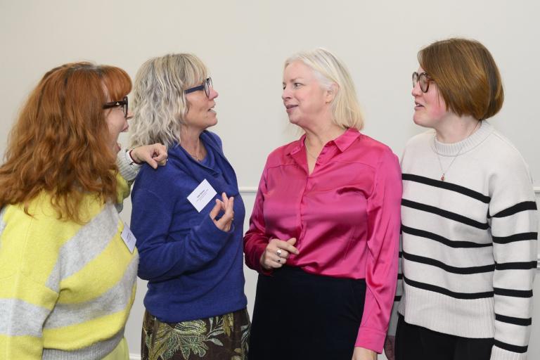 Four ladies stood talking