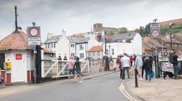 People walking over Whitby Swing Bridge