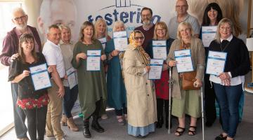 A group of foster carers with certificates