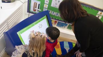 Primary school children being taught by a teacher