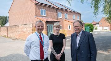 Executive member for housing, Cllr Simon Myers (right), Clare Edwards and North Yorkshire Council’s head of housing, Andrew Rowe, outside the new homes in Ripon. 