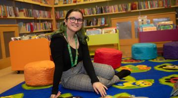 A library volunteer sat in a library