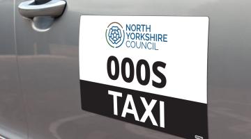 Taxi sign on a car