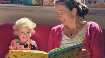 Katie Daynes reading to two-year-old Holly Dembizky at Skipton Library