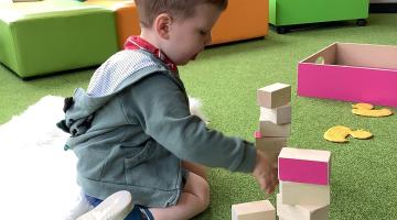 A young boy playing with blocks