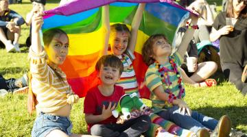 A family with a pride flag