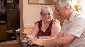 A lady and man using a laptop